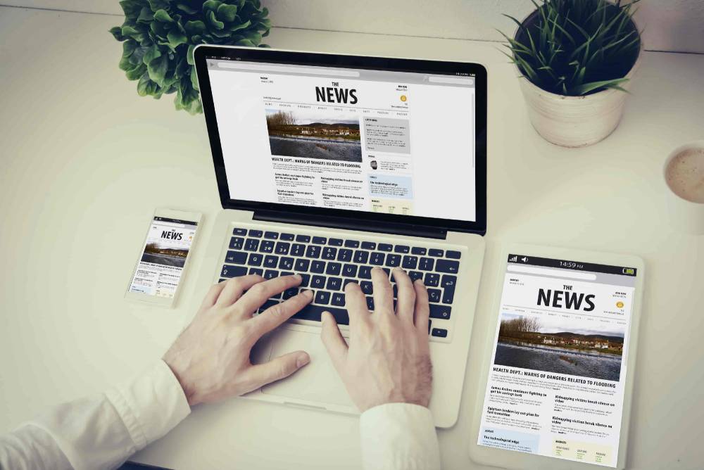 business-technology-responsive-design-concept-hands-writing-laptop-with-phone-tablet-news-website.jpg